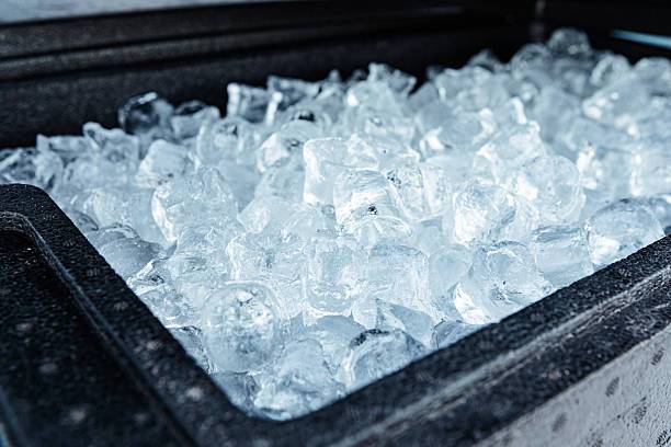 A close up view of a container filled with clear ice cubes